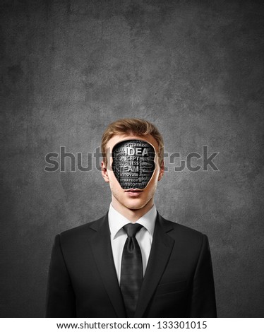 man with business tags inside head on concrete wall background