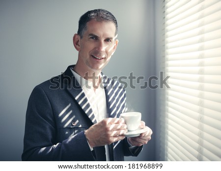 Portrait of businessman with cup of coffee