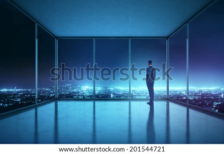 Businessman looking at night city
