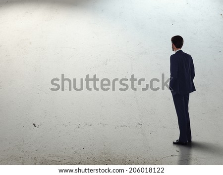 Man in suit standing on concrete floor