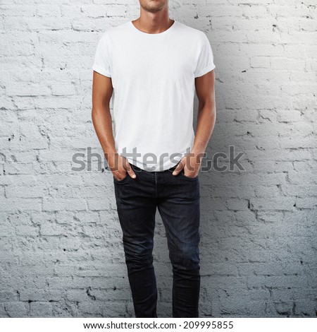 Man wearing blank t-shirt. Brick wall background