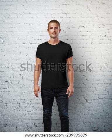 Man in black t-shirt. Brick wall background
