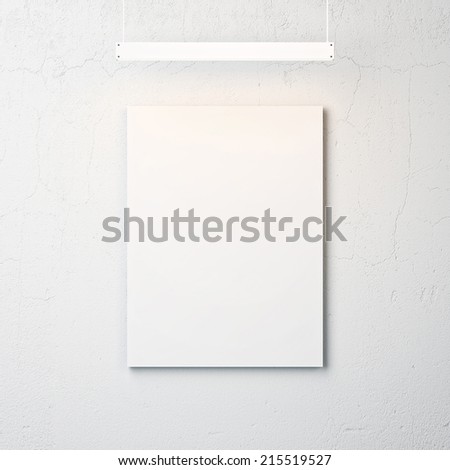 White concrete wall with blank poster and spotlight