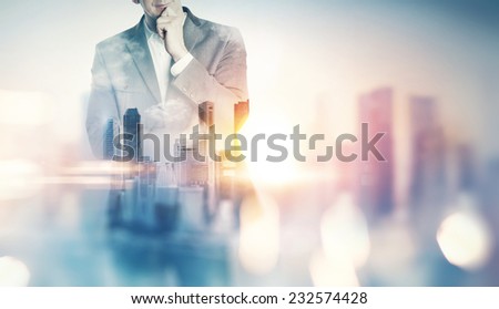 Double exposure of city and business man with light effects
