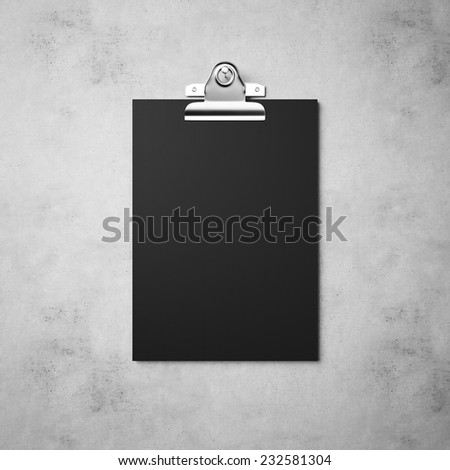 Black paper with clip on the concrete background
