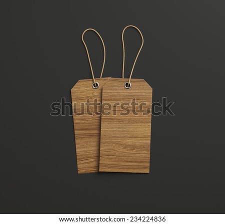 Two labels of wood on black paper background