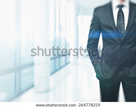 Suited man in the bright office with special effects