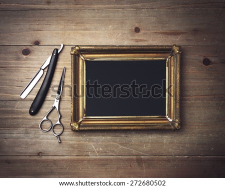 Black canvas with a frame and vintage barber tools