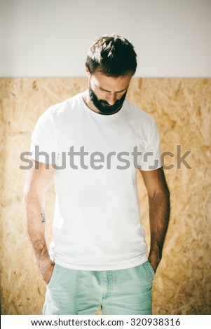 Mockup of a bearded man wearing white tshirt and green shorts