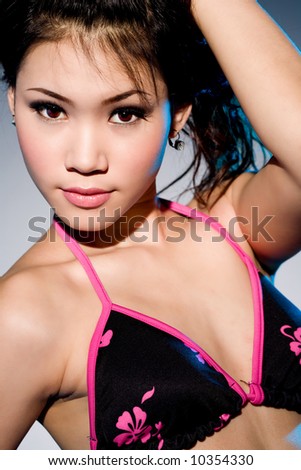 young asian woman in bikini top looking very sexy