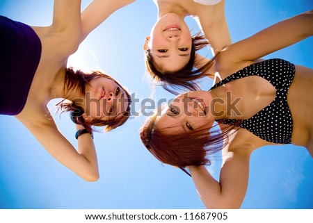 three girls friend having fun under sunny blue sky on summer time