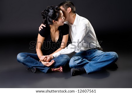 happy asian young couple with the guy kissing on girl cheek