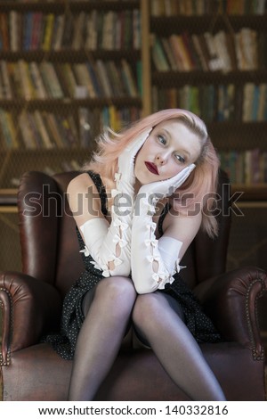 Beautiful caucasian woman wearing long white gloves lost in thoughts in old library