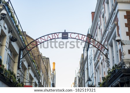 LONDON, UK - MARCH 01: Traditional Carnaby street street sign arch. The street is famous for its fashion stores. March 01, 2014 in London.
