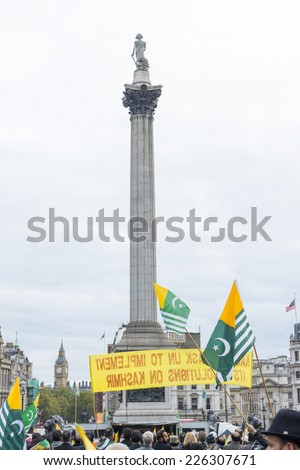 LONDON, UK - OCTOBER 26: Protesters wave Kashmiri flags in Trafalgar Square. The protest, named the Million March, denounced the human rights violation by India in Kashmir. October 26, 2014 in London.