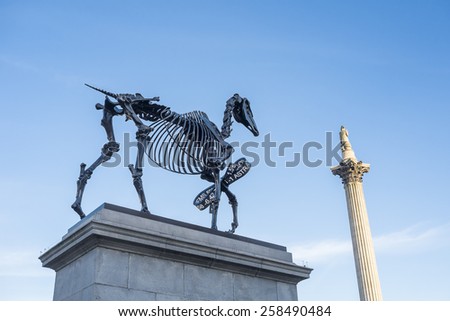 LONDON, UK - MARCH 06: Gift Horse sculpture by Hand Hacke, with Nelson\'s Column in the background, in Trafalgar Square. March 06, 2015 in London. The artwork shows live FTSE 100 tick in its ribbon.