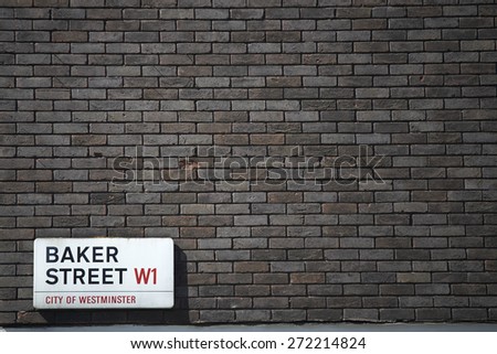 LONDON, UK - APRIL 22: Dark brick wall with Baker Street sign at the bottom corner. April 22, 2015 in London.  The street was brought to fame by Sherlock Holmes\'s adventures.