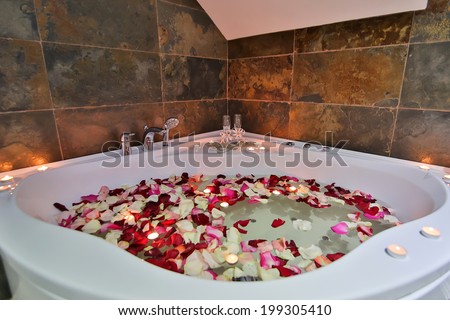 A relaxing candlelit bath with rose petals and a a rubber duck. Low lighting since bathroom was only lit with candles to create relaxing atmosphere