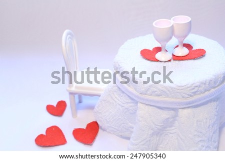 White romantic table in a cafe with white tablecloth and red hearts