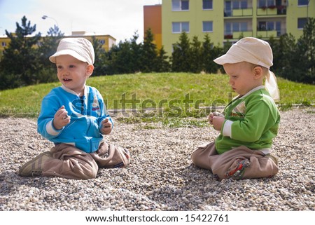Beautiful happy twin brothers playing outdoor