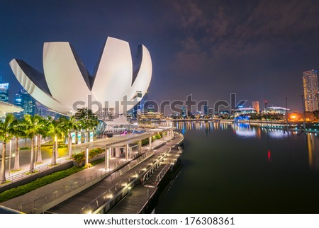 SINGAPORE - JAN 18: ArtScience Museum at night with clolorful light on JAN 18, 2014. It is one of the attractions at Marina Bay Sands. It has 21 gallery spaces with a total area of 6,000 square meters