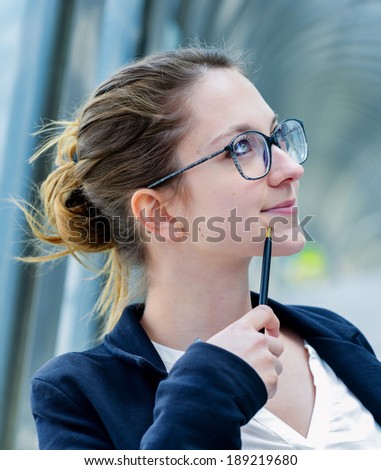 Outdoor portrait of a dynamic junior executive thinking