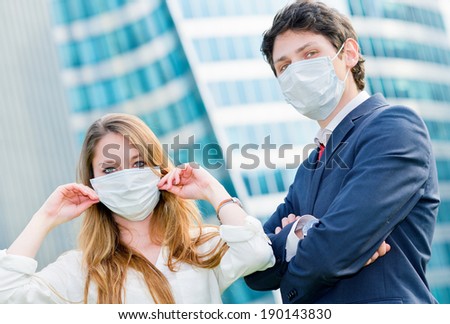 Junior executives dynamics  wearing protective face mask against pollution