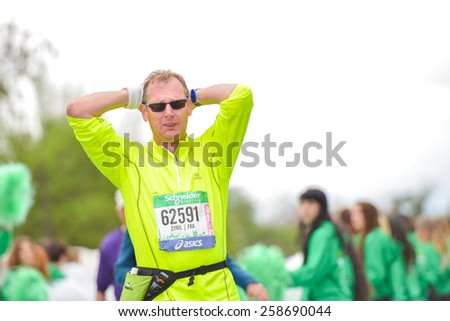 PARIS, FRANCE - APRIL  06 : marathon runner finishing line at Paris International Marathon on April 06, 2014 in Paris, France
