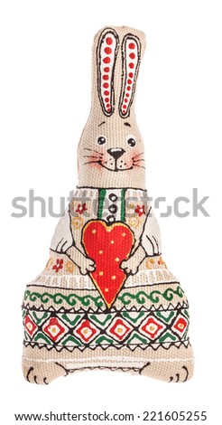 Rabbit toy with heart. The toy is made from natural fabrics and hand-painted Ukrainian artists. Isolated on white