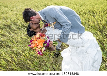 Newly wed couple kissing in a dance position