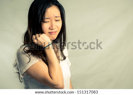 Young woman pulling her hair and crying, with fashion tone