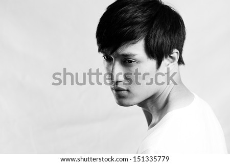 Young man with cool pose, gray background