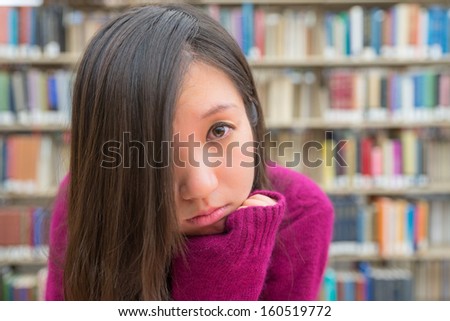 Close portrait of young woman in library