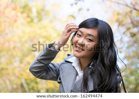 Portrait of young beautiful girl bending forward and tilting her head