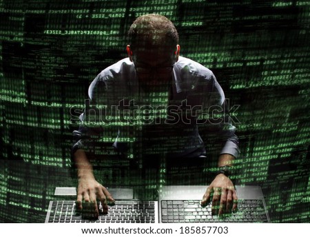 Silhouette hacker in futuristic environment hacking information on tech background with binary codes and words