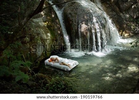 a hidden place. Sleeping woman in deep forest with waterfall on back