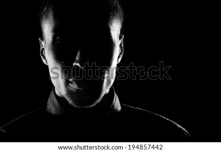 Unknown  male person silhouette.Back lit studio isolated