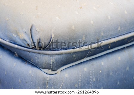 close up of pattern old and dirty blue sofa