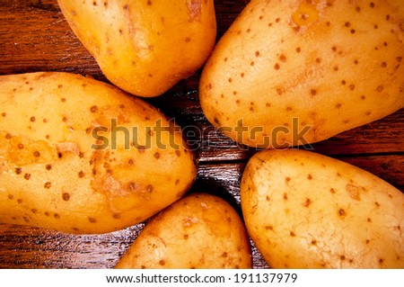 Close up Group of Five Fresh Potato Arrange on Star Shape on Wood Table , Country Rustic Style.