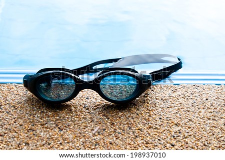 Black Swimming Sport Goggles on the Swimming poolside.