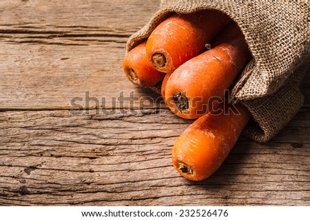 Fresh Harvest Carrot with Vintage Burlap Bag on Wood Table Background, Concept and Idea of Food Cook Rustic Still life Style.