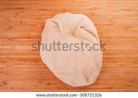 Dough Kneading Ready for Making Bread, Pizza, Pasta and Others Pastry. Concept and Idea of Homemade Fresh Baking and Cooking. Wood Table Background, Still Life Style.