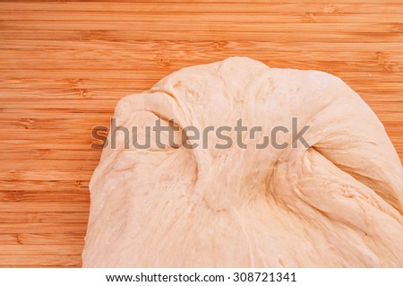 Dough Kneading Ready for Making Bread, Pizza, Pasta and Others Pastry. Concept and Idea of Homemade Fresh Baking and Cooking. Wood Table Background, Still Life Style. Close up.