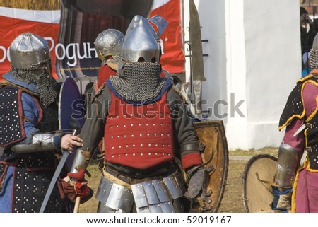 NOVGOROD, RUSSIA - APRIL 11: Members of historical club in armors of medieval knights on folklore festival, April 11, 2010 in Novgorod, Russia