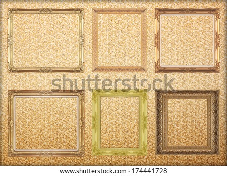 Golden picture frame isolated on yellow  background.