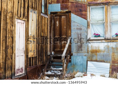 Unique set of doors on an abandoned rusting building