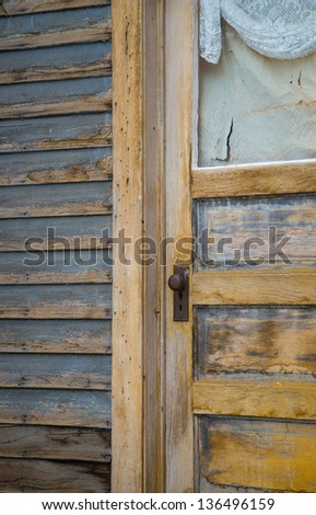 Antique door frame and ripped curtain on an abandoned house