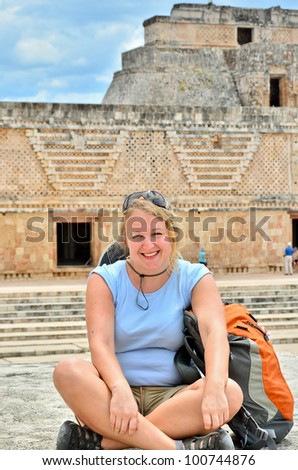 Backpacker girl visiting Uxmal, Mexico - Mayan ruins