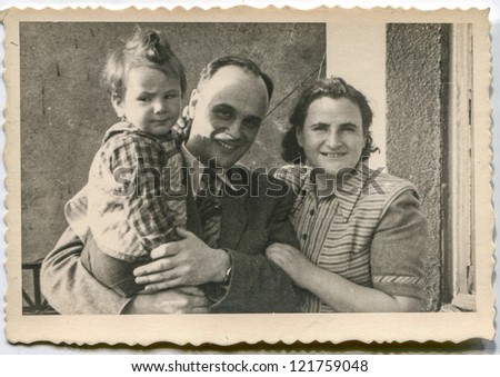 LODZ, POLAND, CIRCA 1955 - Vintage photo of parents and little daughter on balcony, Lodz, Poland, circa 1955