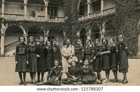 KRAKOW, POLAND, CIRCA 1938 - Vintage photo of group of high schools female students visiting royal castle in Krakow, Poland, circa 1938